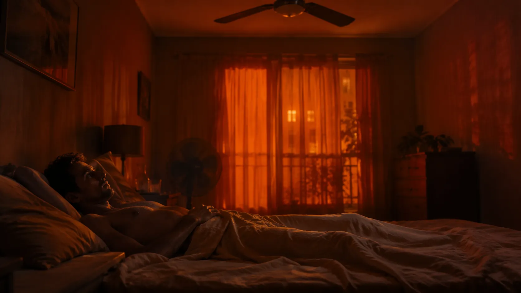 A person lies awake in a hot summer bedroom at 2:00 AM during a heatwave