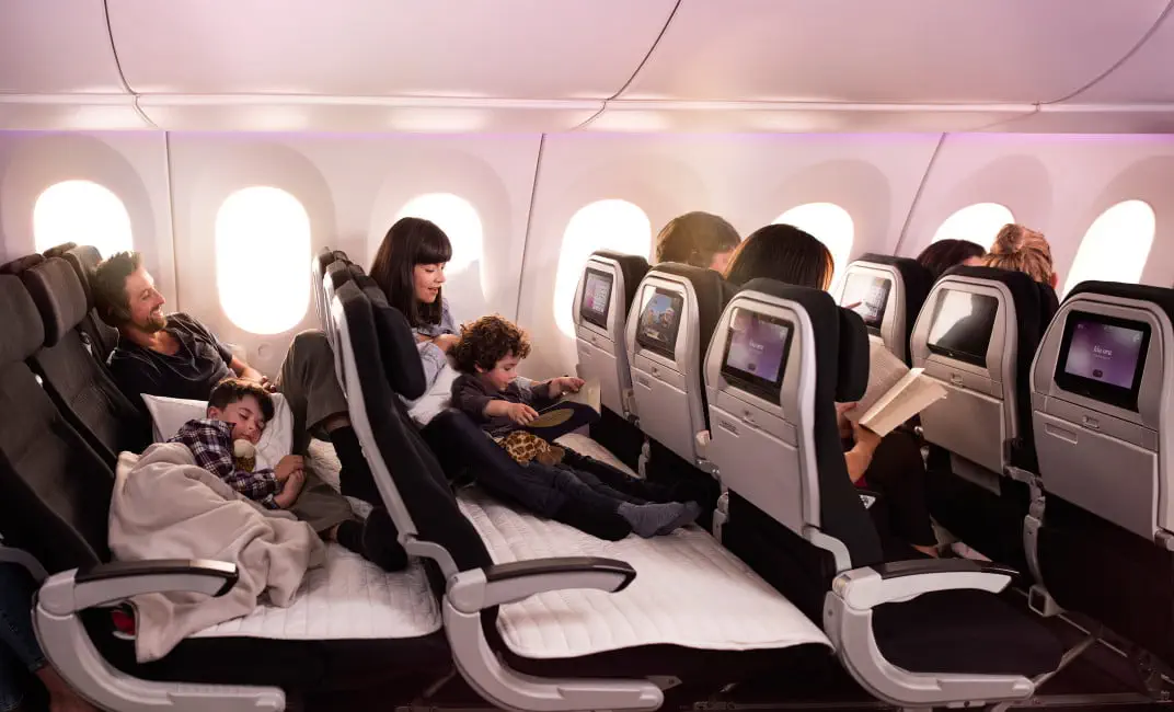 Air New Zealand Skycouch row converted into a flat cushioned economy-class surface for resting