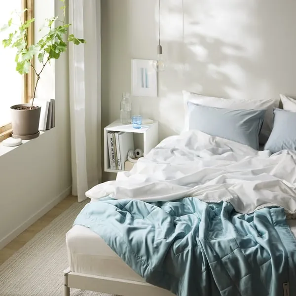 Light blue IKEA BLÅNEPETA duvet insert folded on a white background with quilted stitching visible
