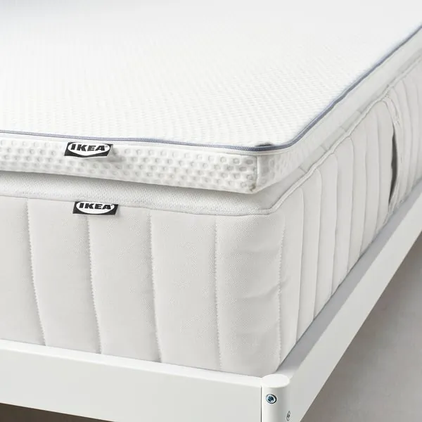 IKEA NÄSTABERG white mattress topper on a bed