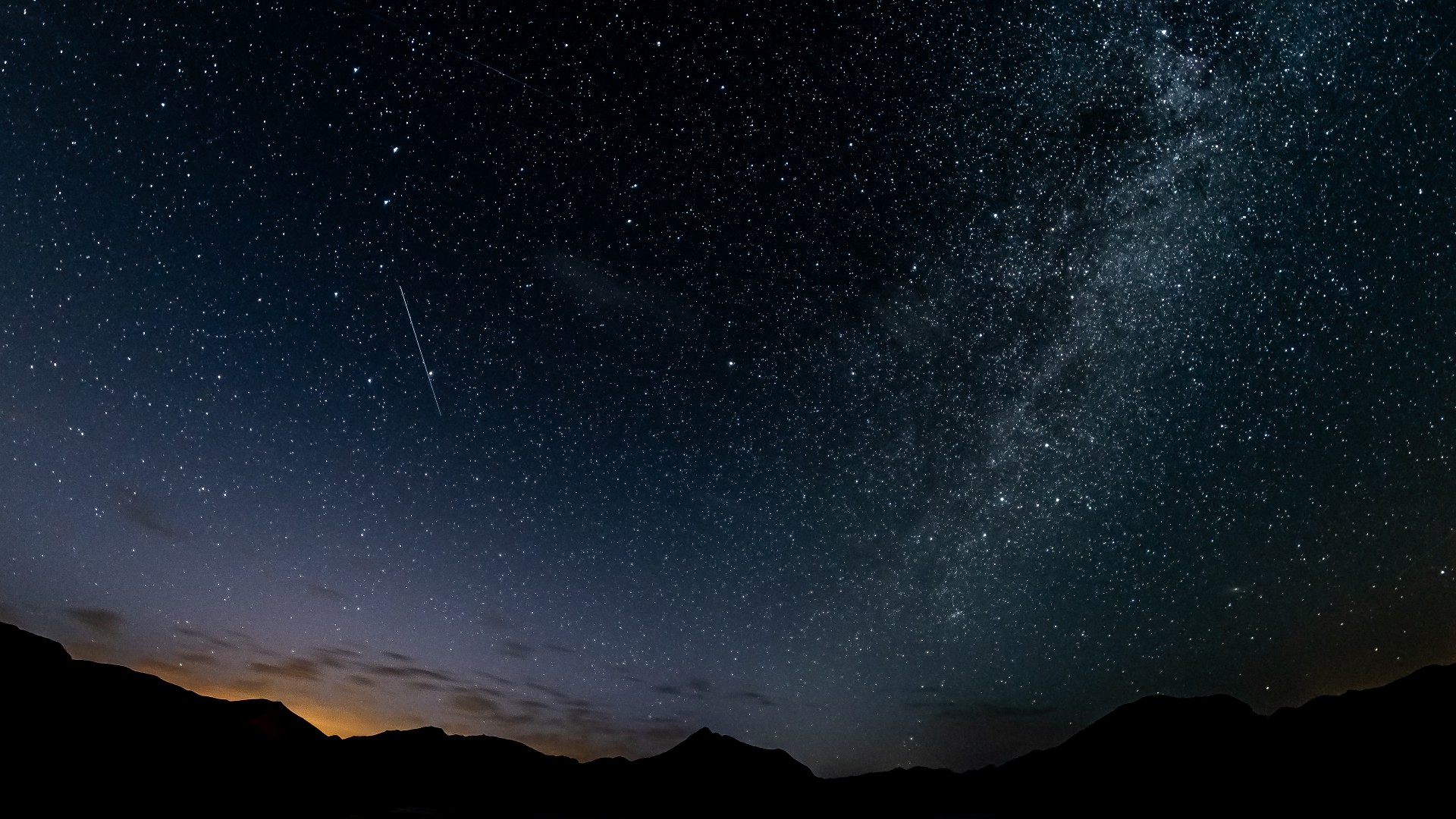 Bright Perseid meteors streaking across a dark star-filled night sky
