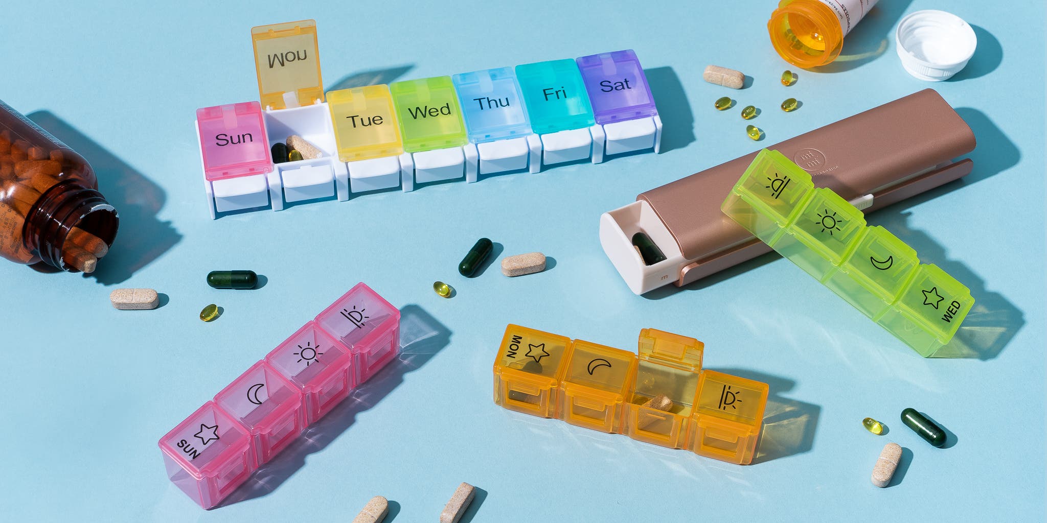 Pill organizers arranged on a table for managing multiple medications