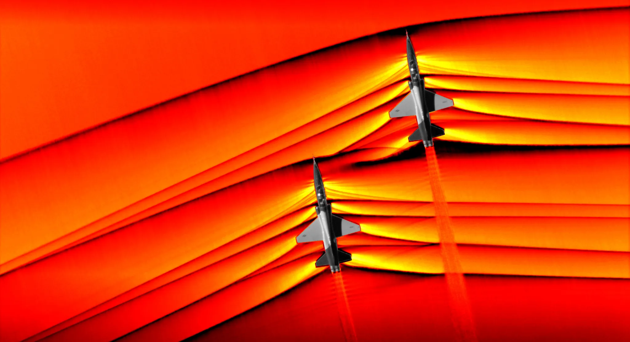 NASA photograph of two supersonic jets with visible shockwave patterns in the sky
