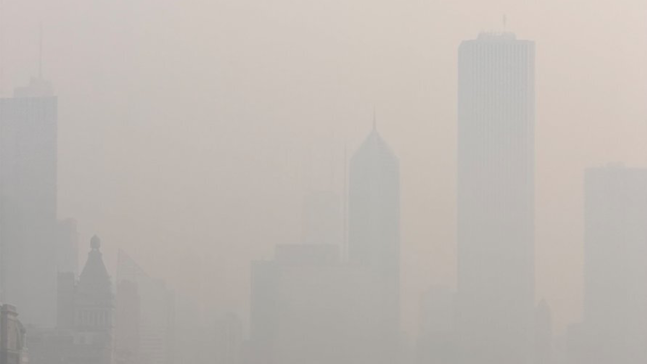 Chicago skyline obscured by orange-gray wildfire smoke haze during the July 2026 air quality crisis