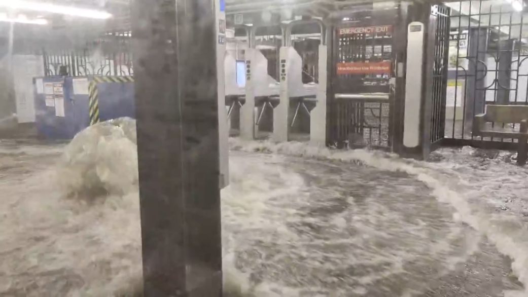 Flooded subway car with murky water covering the aisle and seats during heavy rainfall