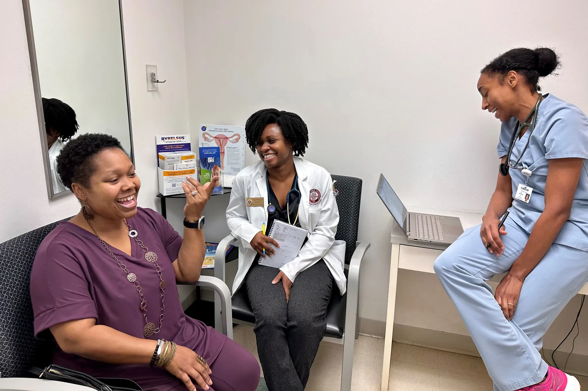 A rural clinician speaking with a pregnant patient in a clinic setting